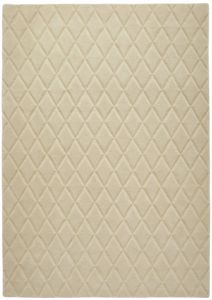 Luxury rug from The Priory Wool Collection featuring a diamond quilted pattern in soft beige