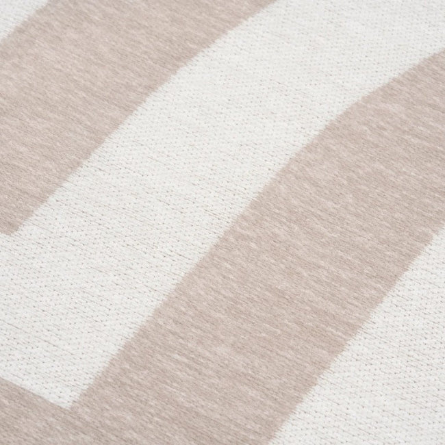 Close-up of a rug with beige and white geometric pattern