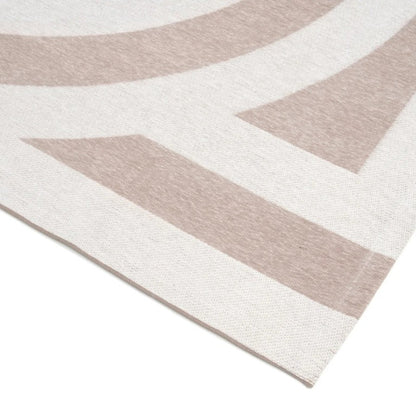 Close-up of a rug with geometric pattern on a plain background