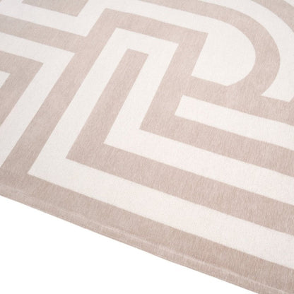Close-up of a beige and white geometric patterned rug