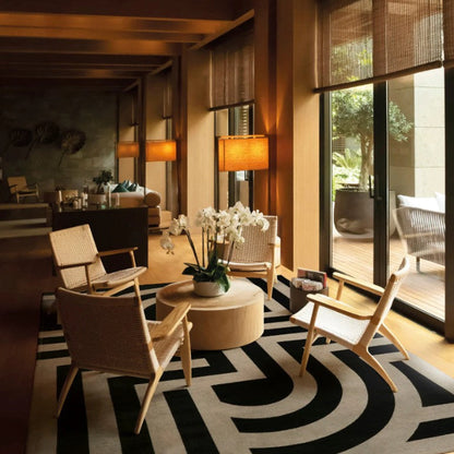 Modern living room with wicker chairs, round table, and decorative elements.