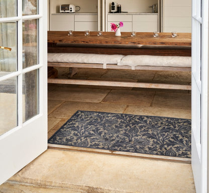 Turtle Mats Thistle Design indoor Mat placed at doorway with floral pattern in a kitchen setting