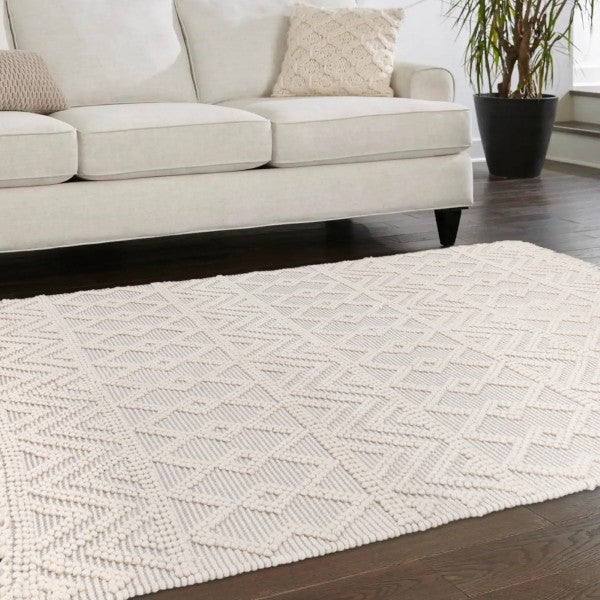 Luxury Boho Collection Asra Rug by Asiatic in cream with geometric textured pattern on wooden floor