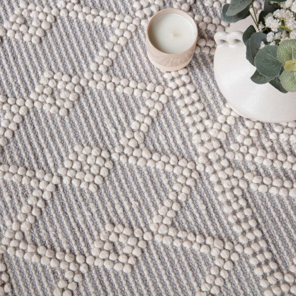 Close-up of luxury Boho Collection Asra Rug by Asiatic in beige and grey with textured pattern