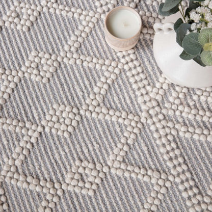 Close-up of luxury Boho Collection Asra Rug by Asiatic in beige and grey with textured pattern
