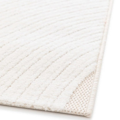Close-up of a textured white rug corner on a light background